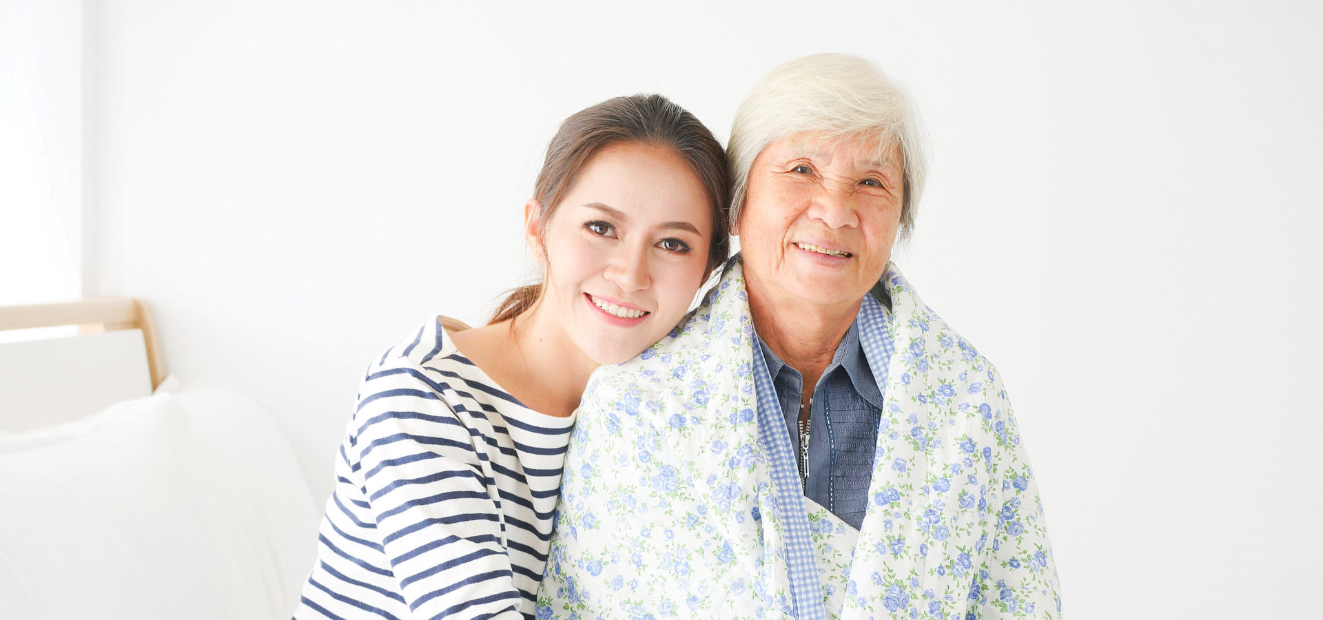 happy senior woman with herd daughter