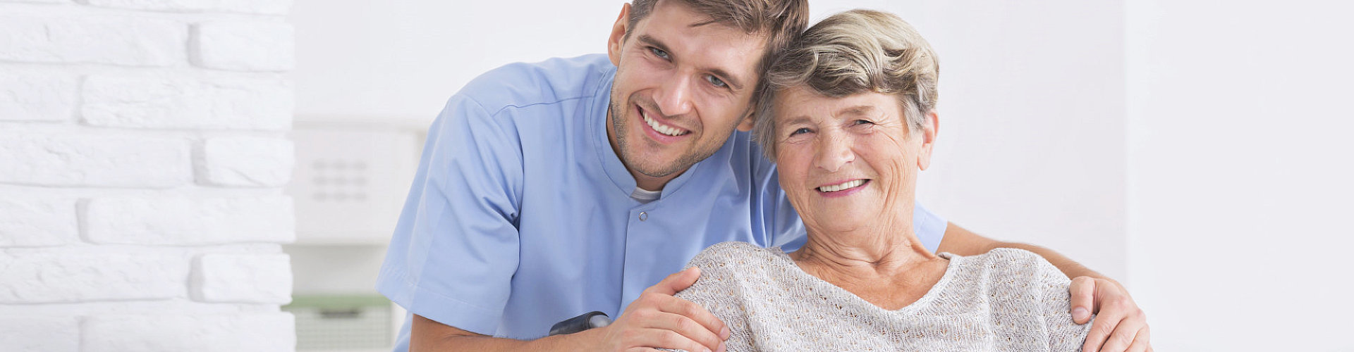 Senior woman and caregiver smiling 