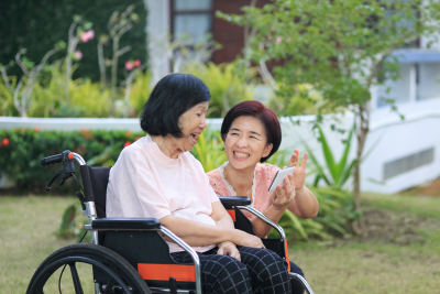 happy senior woman with her caregiver