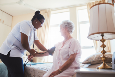 caregiver serving senior woman