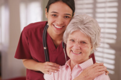 caregiver and senior woman smiling