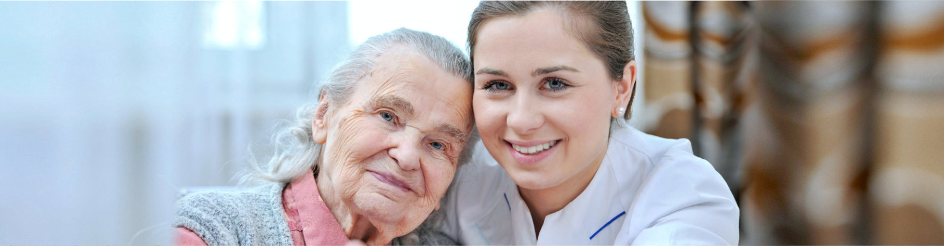 Senior woman and female nurse are showing thumbs up